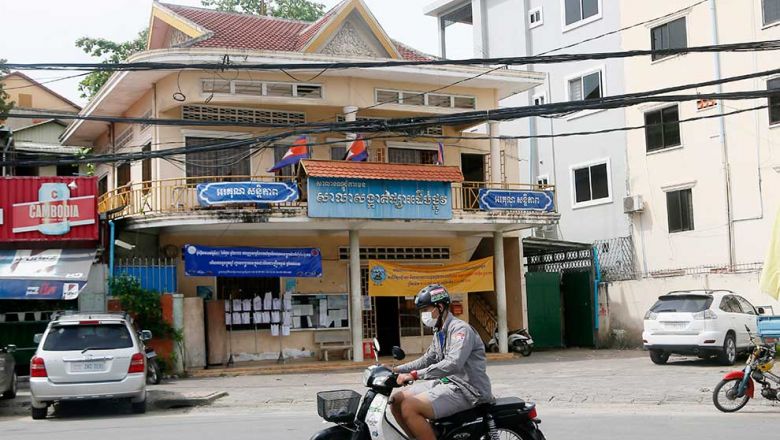 A man rides past Phsar Doeum Thkov commune hall in Chamkarmon district on Wednesday. Heng Chivoan Content image - Phnom Penh Post