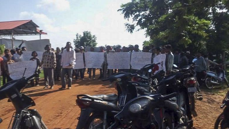 People hold placards as they block a road in Battambang province earlier this month during a protest regarding an ongoing land dispute. Photo supplied People hold placards as they block a road in Battambang province earlier this month during a protest regarding an ongoing land dispute.