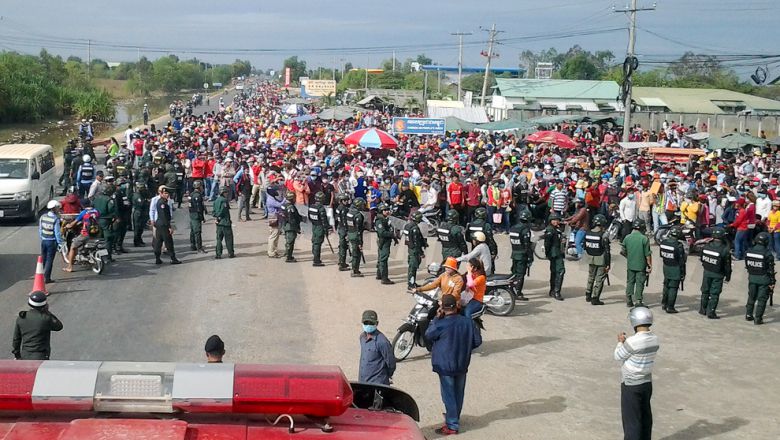 Military police form a line in front of protesting garment factory workers last week in Bavet near a special economic zone.